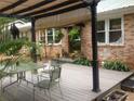 Backyard patio features a covered seating area, plants, and view of the brick exterior of the house at 2225 Harold Se Ln, Smyrna, GA 30080