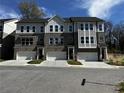 Attractive townhouses featuring a brick facade, multi-pane windows, and two-car garages at 235 W Marietta St, Canton, GA 30114