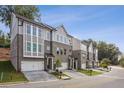 Attractive townhouses featuring a brick facade, multi-pane windows, and two-car garages at 235 W Marietta St, Canton, GA 30114