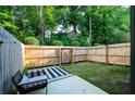 Fenced backyard with patio, black and white rug, and outdoor seating at 4175 Spring Valley Cir, Tucker, GA 30084