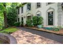 Long driveway leading to home with arched windows and manicured bushes at 735 Wood Valley Trce, Roswell, GA 30076