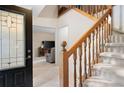 Inviting foyer with wood staircase, decorative door, and tile flooring at 735 Wood Valley Trce, Roswell, GA 30076