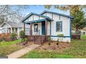Charming single-Gathering home with blue and white exterior, front porch, and a well-maintained lawn at 819 Humphries St, Atlanta, GA 30310
