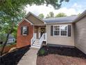 Inviting front entrance with a decorative wreath, sidelights, and a well-maintained yard at 803 Plantation Ridge Overlook, Woodstock, GA 30188