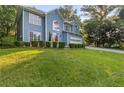 Charming two-story home with blue siding, an attached garage, and a well-manicured front lawn at 1901 Cherwell Dr, Riverdale, GA 30296