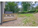 Wooden backyard deck with chairs, a small storage shed and a grassy yard at 41 Spring Nw Ln, Atlanta, GA 30314