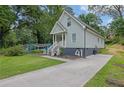 Quaint two-story home with light blue siding and a concrete driveway at 41 Spring Nw Ln, Atlanta, GA 30314