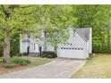 Inviting two-story home with a well-maintained front yard and an attached two-car garage at 6230 Lillie Ln, Cumming, GA 30040