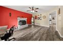 Bright living room with wood floors and a cozy fireplace at 135 Dunwick Ln, Mcdonough, GA 30253