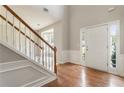 Bright foyer with hardwood floors, staircase, and ample natural light creates a welcoming entrance at 144 Nocatee Trl, Woodstock, GA 30188