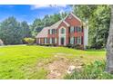 Attractive brick home with well-kept lawn and landscaping, showcasing classic architectural details at 2260 Cobble Creek Ln, Grayson, GA 30017