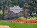 Stone entrance sign for Pebble Creek Farm features manicured lawn and flower beds at 2260 Cobble Creek Ln, Grayson, GA 30017
