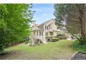 Expansive backyard featuring a charming elevated porch and lush green lawn at 4096 Vinings Mill Se Trl, Smyrna, GA 30080