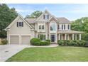 Charming two-story home features a two-car garage, manicured lawn, and stone architectural details at 4096 Vinings Mill Se Trl, Smyrna, GA 30080