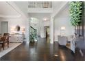 Elegant foyer with high ceilings, hardwood floors, staircase, and views of the dining and living areas at 5828 Paliser Trce, Sugar Hill, GA 30518