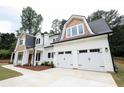 A lovely home with a prominent three-car garage and a beautiful light-colored exterior at 219 Poplar Nw St, Lilburn, GA 30047