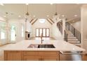 Modern kitchen featuring a spacious island, open floor plan, and abundant natural light at 219 Poplar Nw St, Lilburn, GA 30047