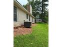 A view of the side yard, chimney, and the home's exterior features at 6103 Chaseland Dr, Rex, GA 30273