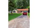 Inviting single-story home featuring a private driveway and well-maintained lawn at 6103 Chaseland Dr, Rex, GA 30273