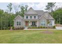 Charming two-story home with stone accents and a well-manicured lawn with plenty of trees at 783 Phil Haven Ln, Kennesaw, GA 30152