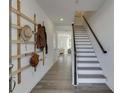 Inviting foyer showcasing a custom coat rack and staircase to the upper level at 1726 Gunnin Nw Trce # 231, Atlanta, GA 30318
