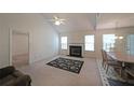 Bright living room featuring a fireplace, vaulted ceiling, and an adjacent dining area at 2374 Brandenberry Ct, Decatur, GA 30034