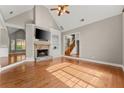 Spacious living room with hardwood floors, stone fireplace, and vaulted ceilings at 7615 Abbey Glen Dr, Cumming, GA 30028
