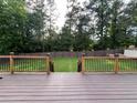 Large backyard with deck and wooden railing, perfect for outdoor enjoyment at 1128 Carillon Dr, Conyers, GA 30013