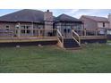 Spacious wooden deck with stairs leading to the backyard and a covered gazebo at 1128 Carillon Dr, Conyers, GA 30013