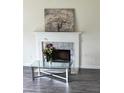 Living room fireplace featuring white mantle with light-colored marble surround at 2915 Camelot Woods Dr, Lawrenceville, GA 30044