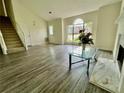 Bright living room boasts wood floors, a fireplace, and a large window providing natural light at 2915 Camelot Woods Dr, Lawrenceville, GA 30044