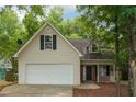 Charming home featuring a two-car garage, dormer windows, mature trees, and low-maintenance landscaping at 6 Stonebridge Se Ct, Cartersville, GA 30121