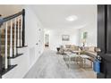 Bright living room features plush carpet, stylish furnishings, and open staircase at 6 Stonebridge Se Ct, Cartersville, GA 30121