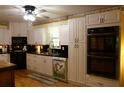 White kitchen featuring black countertops, stainless steel appliances, and ample storage at 259 Gramling Trl, Canton, GA 30114