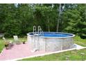 Outdoor above ground pool with patio, perfect for summer entertaining at 259 Gramling Trl, Canton, GA 30114