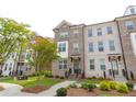 Attractive brick townhomes with manicured lawns, lush landscaping, and inviting curb appeal at 3195 Bartee Walk, Suwanee, GA 30024