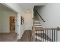 Bright foyer featuring hardwood floors, staircase, and doorway to a bathroom at 3195 Bartee Walk, Suwanee, GA 30024
