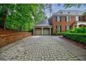 Attached garage and a stone paver driveway add functionality and curb appeal to this classic brick home at 663 Clifton Ne Rd, Atlanta, GA 30307