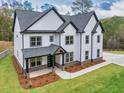 Stunning two-story home showcasing black trim and a lush green lawn at 1387 Mineral Springs Rd, Hoschton, GA 30548