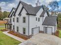 Gorgeous home with clean lines, modern garage doors, and impeccable landscaping at 1387 Mineral Springs Rd, Hoschton, GA 30548