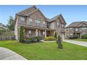 Beautiful two-story home with brick accents, lush landscaping, and a well-maintained lawn at 5445 Whisper Ct, Cumming, GA 30028