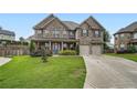 Beautiful brick home with a two-car garage and a well-maintained front yard at 5445 Whisper Ct, Cumming, GA 30028