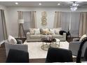 Bright living room featuring neutral tones, a comfortable sofa, modern decor and recessed lighting at 2349 Ousley Ct, Decatur, GA 30032