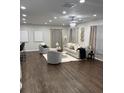 Spacious living room with hardwood floors, neutral furniture, modern lighting, and large windows at 2349 Ousley Ct, Decatur, GA 30032