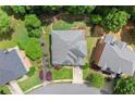 Aerial view of home with lush backyard, mature trees, and circular driveway in a quiet neighborhood at 4896 Locklear Way, Marietta, GA 30066