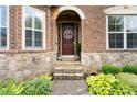 Inviting front entrance featuring stone accents, brickwork, and a charming wreath on the front door at 4896 Locklear Way, Marietta, GA 30066