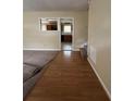 Inviting living room featuring wood-look floors and a view into the kitchen at 213 Peartree Ln, Riverdale, GA 30274
