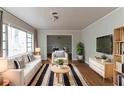 Bright living room features hardwood floors, neutral paint, and large windows for natural light at 2582 Springdale Sw Rd, Atlanta, GA 30315