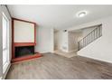 Spacious living room featuring a brick fireplace, hardwood floors and staircase at 3184 Nectarine Cir, Decatur, GA 30034