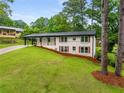 Charming home with a covered porch and well-manicured lawn, surrounded by mature trees at 3536 Redwine Ct, Atlanta, GA 30344